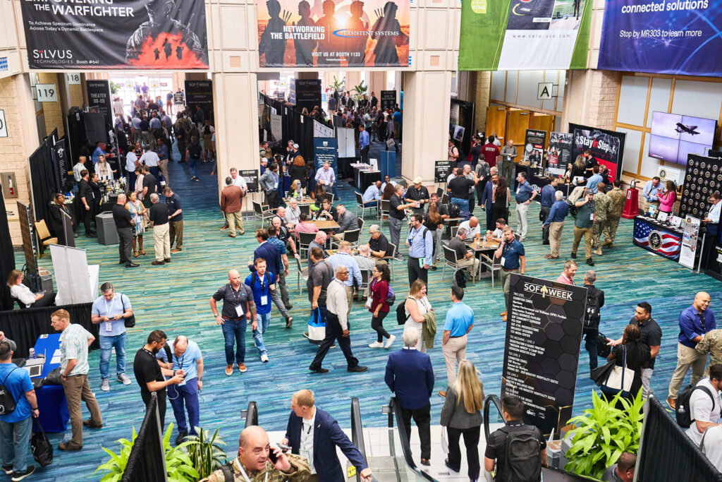 SOF Week conference event with networking booths, attendees, and presentations at a large convention center, showcasing technology industry engagement and trade show activities.
